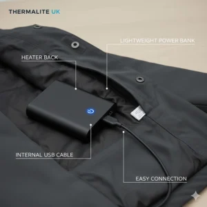 A close-up of a lightweight portable power bank connecting to the internal USB cable of an electric heated jacket.