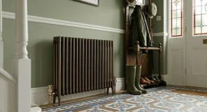 A display of bespoke coloured column radiators showing a variety of custom RAL paint finishes like navy blue and forest green.