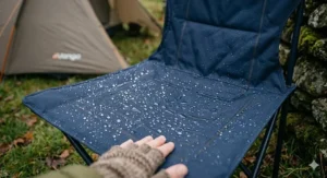 Detail of the water-resistant fabric on a heated outdoor chair during a light British drizzle.