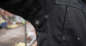 Close-up of an illuminated LED button used to control temperature settings on a heated jacket.