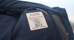 Close-up of CE and UKCA safety certification labels inside a protective heated FR work jacket.
