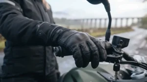 Rider demonstrating handlebar grip and finger dexterity while wearing padded heated gloves