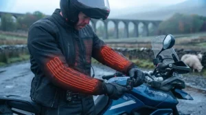 Highlighting full-sleeve thermal coverage on a heated motorcycle jacket for motorway riding.