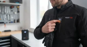 Easy-to-use LED temperature control button on a budget heated motorcycle jacket for adjusting warmth levels on the move.