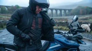 Demonstrating how a slimline heated vest fits comfortably underneath an armoured textile motorbike jacket.