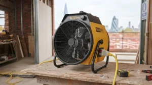 Robust 110V portable fan heater featuring a protective safety grille for site use.