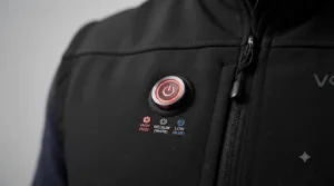 A close-up of the chest-mounted control button displaying three heat settings on a trade heated gilet.