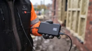 Illustration of a safety-certified USB battery pack powering a heated vest for site use.