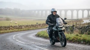 Motorcyclist commuting on a frosty morning using heated gloves for winter weather protection