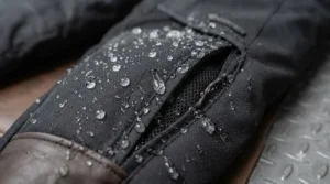 Detailed view of CE-approved knee armour pockets built into waterproof heated motorcycle trousers.