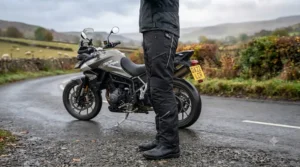 Close-up of the power controller and battery connection wiring on heated motorcycle trousers for winter commuting.
