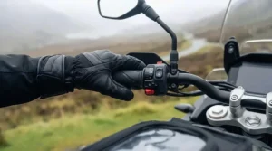 Adventure touring motorcycle packed with luggage and equipped with handguards and heated grips.