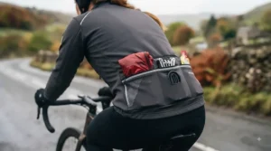 Deep, easily accessible rear storage pockets on a heated cycling jacket for carrying ride essentials.