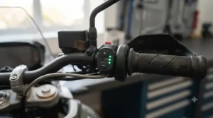 Close-up of a handlebar-mounted LED temperature control switch for heated motorcycle grips set to a medium heat level.
