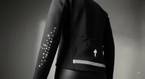 Reflective details on a heated cycling jacket for improved visibility during evening winter rides