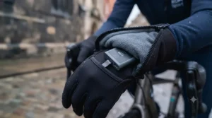 Cyclist using a smartphone GPS navigation app while wearing touch-sensitive heated cycling gloves