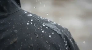 Water beading off the breathable, showerproof fabric of a thermal cycling jacket during a wet winter ride.