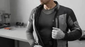Water-resistant and windproof outer shell material of a heated motorcycle vest for touring in unpredictable British weather.