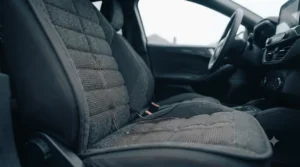 Heat distribution zones warming both the backrest and base of a heated car seat cushion.
