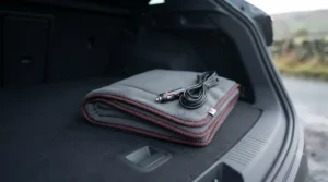 A compactly folded 12V heated car blanket stored neatly inside a car boot ready for travel