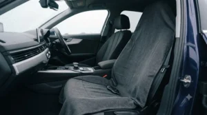 Full-length view of a 12V heated travel blanket neatly draped over a car passenger seat.