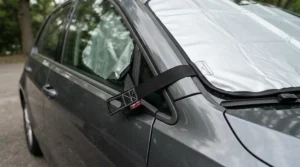 Secure heated windscreen covers featuring locked door flaps to prevent theft on a city street