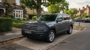 Universal-fit heated windscreen covers attached properly to a large SUV on a residential road